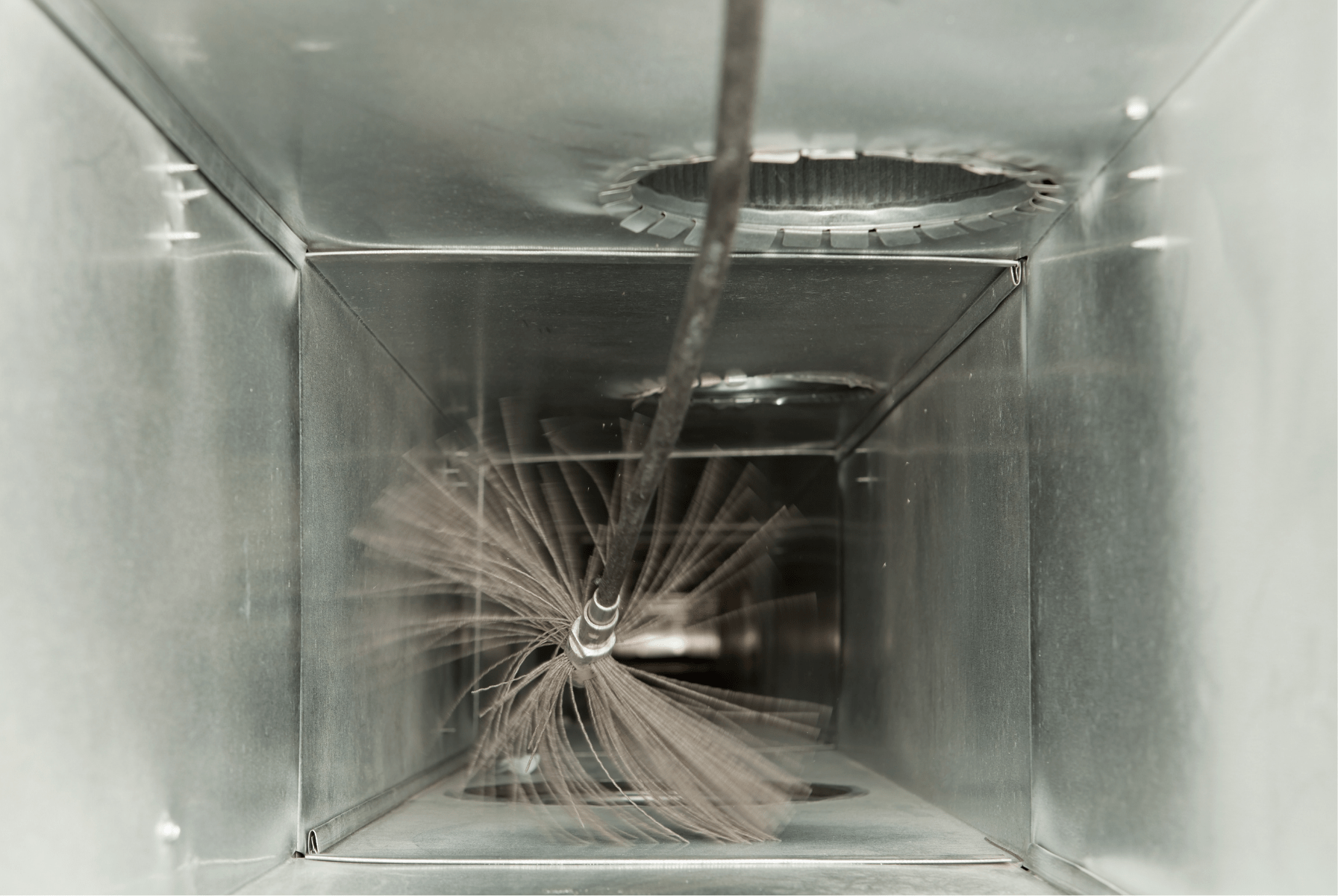 Rotating brush cleaning dust from inside air ducts ,Des Moines